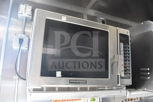 Commercial Menumaster microwave inside a 2021 Rock Solid Cargo food trailer with visible electrical outlets.