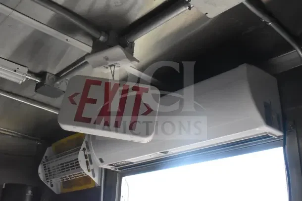 Interior view of 2021 Rock Solid Cargo food trailer showing the "Exit" sign and air conditioning unit.