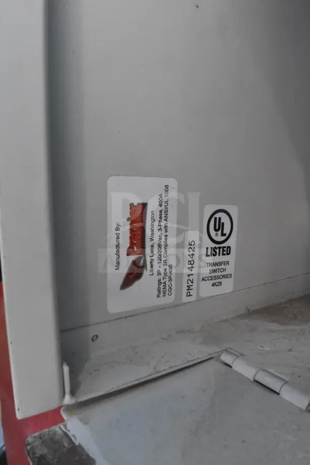 Close-up view of a UL listed transfer switch accessory label and manufacturer information on a 2021 Rock Solid Cargo food trailer.