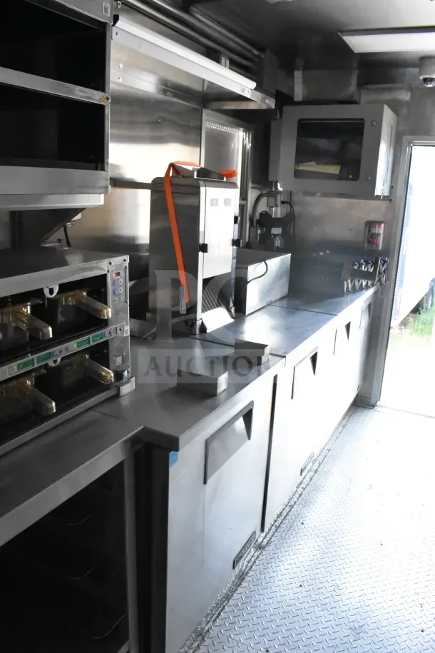 2021 Texino 8.5'x28' food trailer interior with CaptiveAire grease hood, fire suppression, refrigeration, and breading tables.