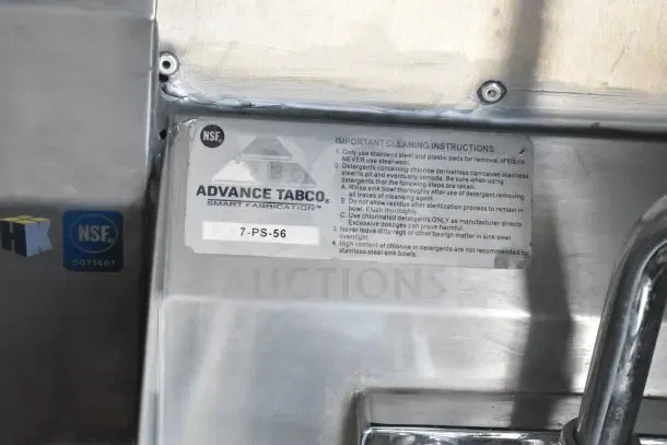 "Advance Tabco cleaning instructions label on a stainless steel surface, featuring NSF and HK certifications."