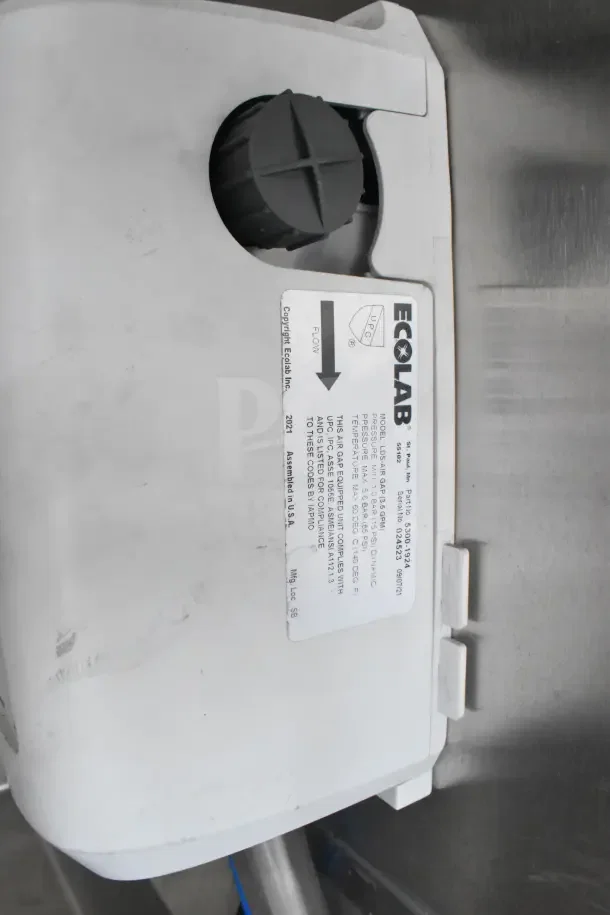 Ecolab sanitation unit with label, detailing model LS10SR and pressure specifications. Assembled in USA, 2021.