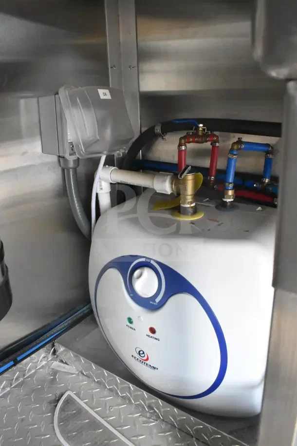Interior view of Texino food trailer showing an Eccotemp water heater with control knob and power, heating indicators.