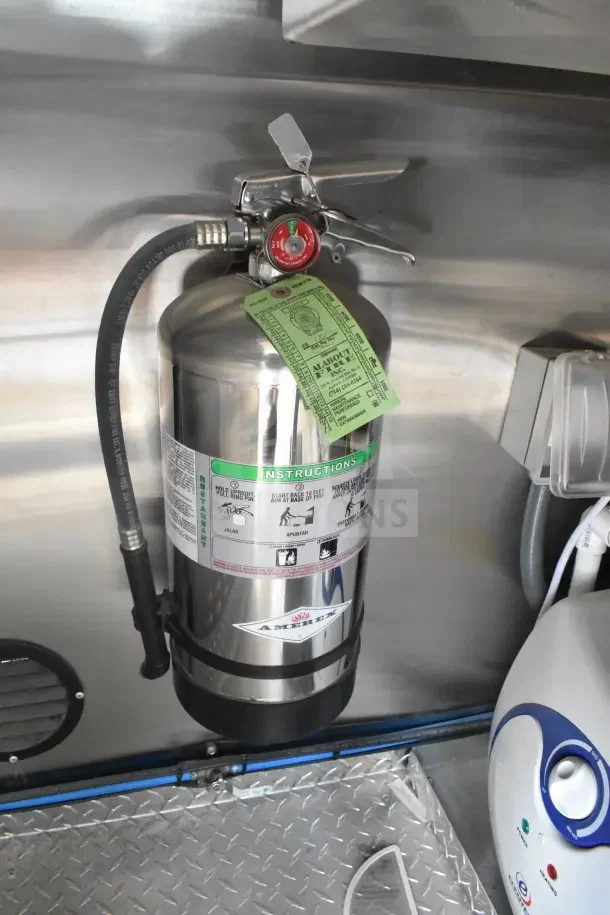 2021 Texino 8.5'x28' food trailer's fire suppression system, featuring an Amerex extinguisher with instruction labels.