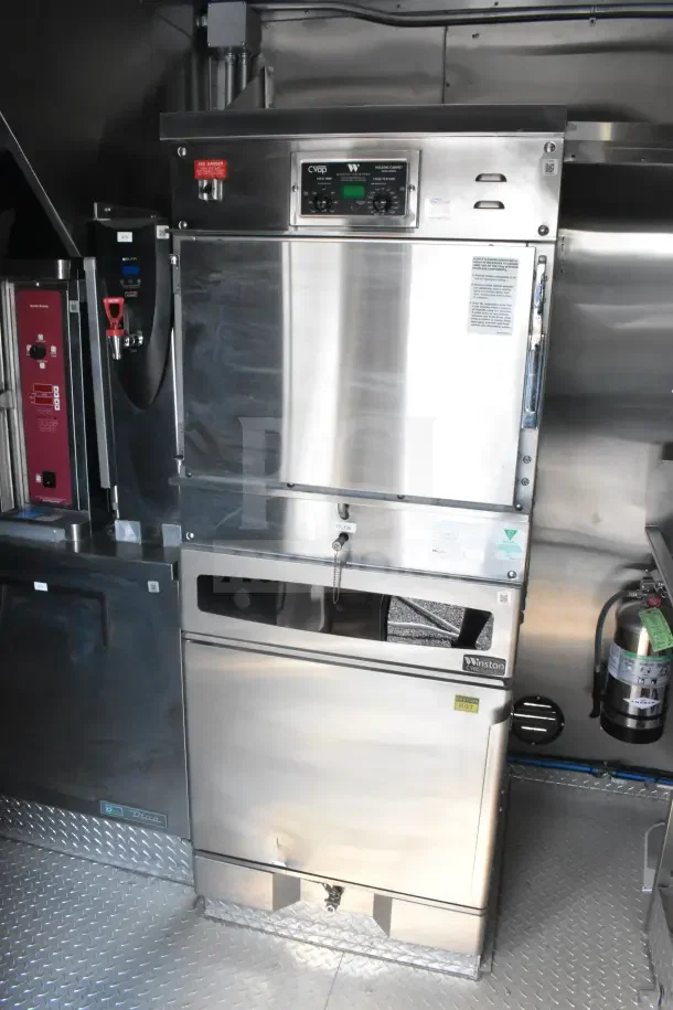 2021 Texino 8.5'x28' food trailer interior featuring CaptiveAire grease hood, fire suppression system, and refrigeration units.