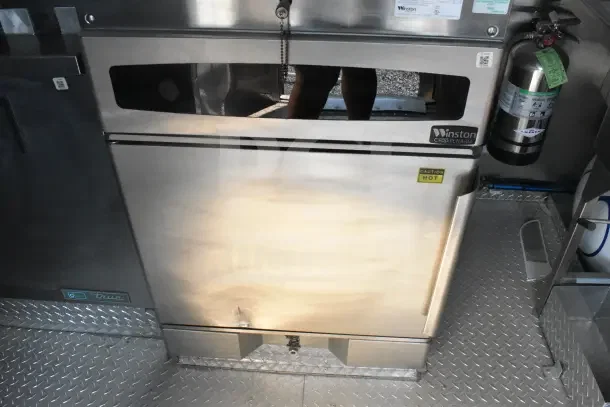 2021 Texino 8.5'x28' food trailer interior showing Winston CVap retherm oven, fire extinguisher, and diamond plate flooring.