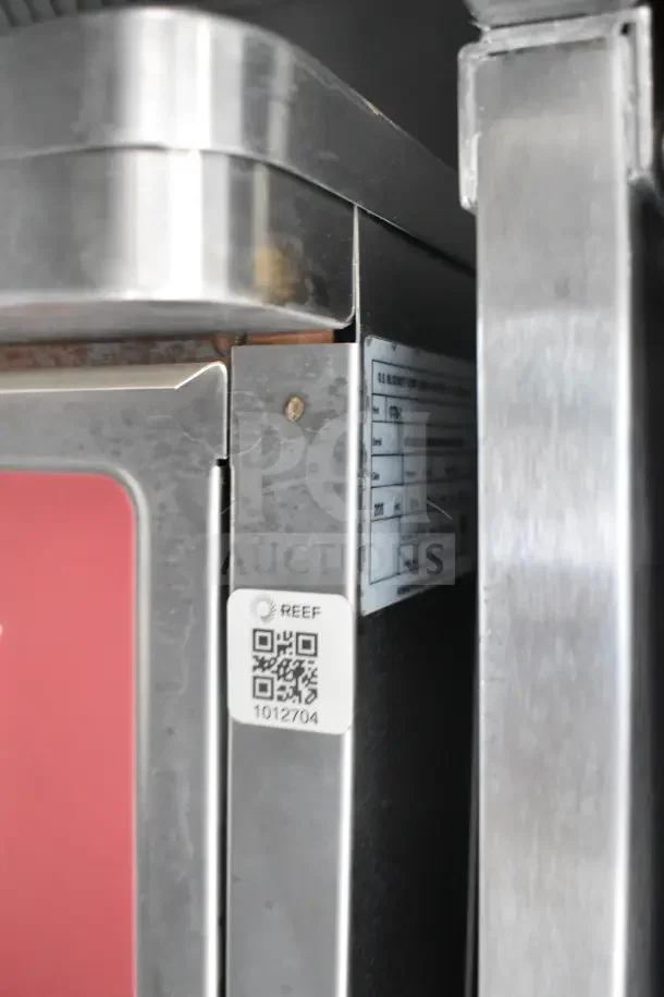 QR code label on Texino food trailer equipment, showing "REEF 1012704" marking for identification.