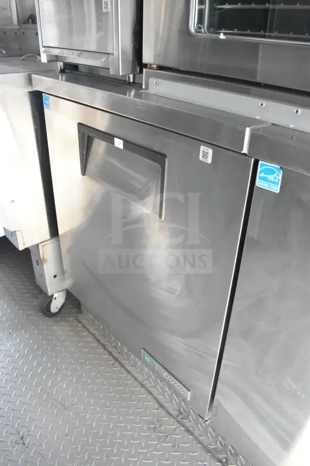 2021 Texino 8.5'x28' food trailer interior, featuring CaptiveAire grease hood, fire suppression, refrigeration, and breading tables.