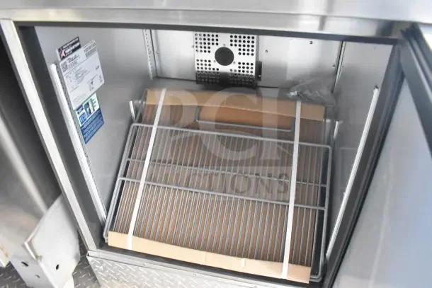 2021 Texino food trailer interior, showing refrigeration unit with shelving and labels detailing specifications.