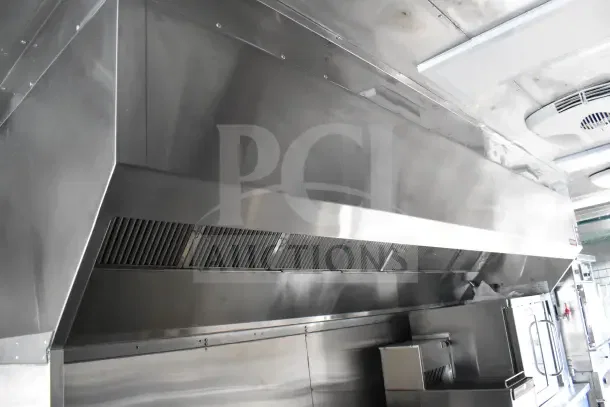 2021 Texino 8.5'x28' food trailer with CaptiveAire grease hood and fire suppression system. Includes refrigeration and breading tables.