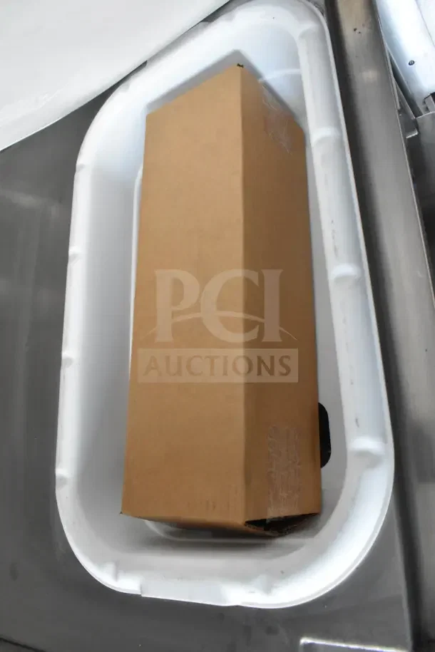 Cardboard box in a white food trailer compartment, part of 2021 Texino 8.5'x28' trailer auction item.