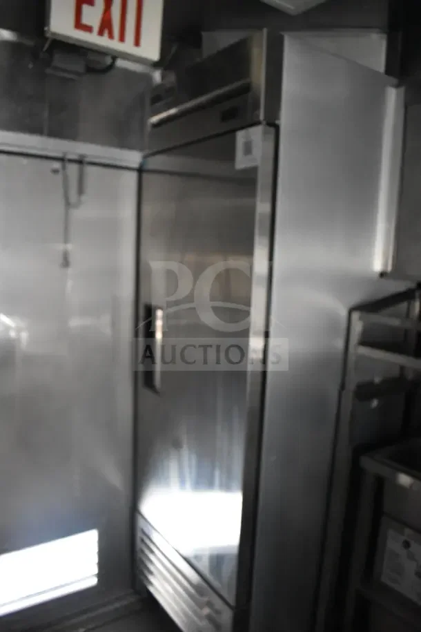 2021 Texino 8.5'x28' food trailer interior showing refrigeration unit, steel fixtures, and partial CaptiveAire grease hood.