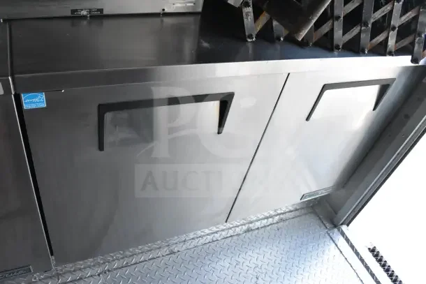 2021 Texino 8.5'x28' food trailer interior, featuring stainless steel refrigeration unit, diamond plate floor, Energy Star label.