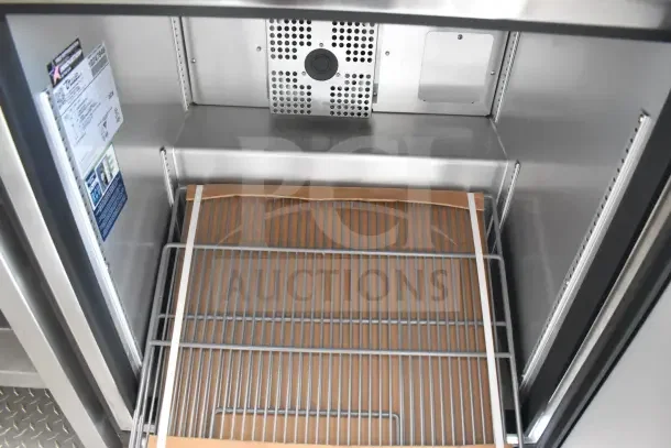 Interior of a 2021 Texino 8.5'x28' food trailer featuring a refrigeration unit with shelving. Visible tags display model and specs.