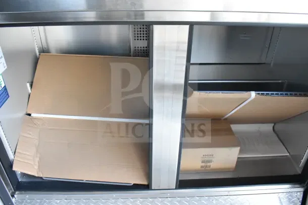 2021 Texino 8.5'x28' food trailer interior, showing storage area with boxes. Durable stainless steel construction.