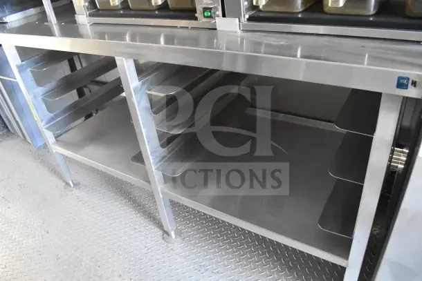 2021 Texino 8.5'x28' food trailer; features stainless steel breading tables and shelving, in excellent condition.