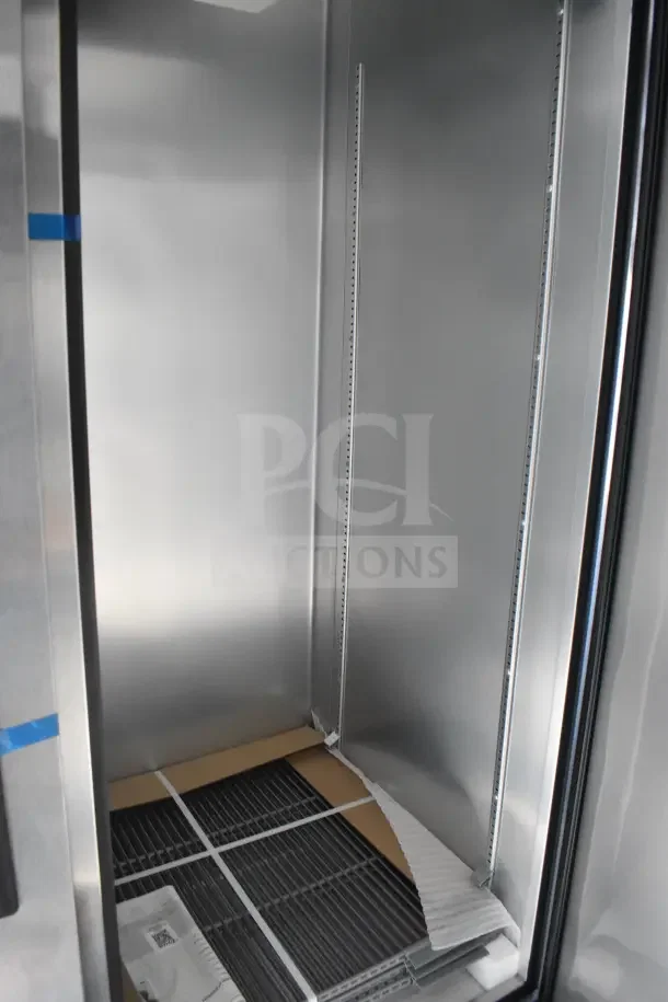 Interior of 2021 Texino food trailer showing stainless steel walls and shelving. Includes refrigeration and storage space.