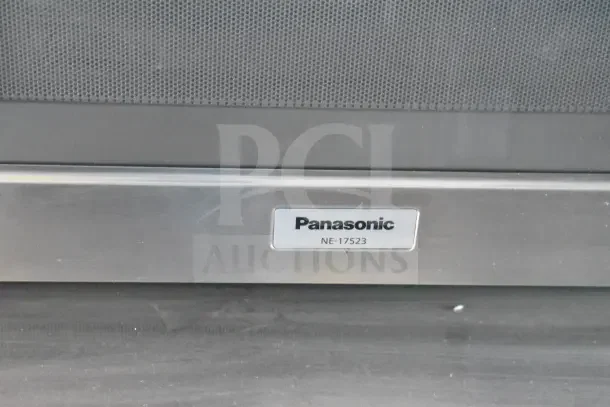 Close-up of Panasonic NE-17523 label on stainless steel appliance.