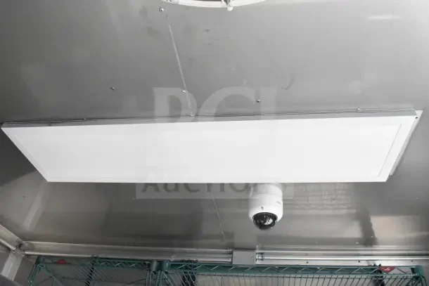 Interior of 2021 Texino food trailer showing ceiling-mounted CaptiveAire grease hood and security camera.