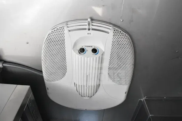 Dometic air conditioner unit inside a Texino food trailer, model B16, with control knobs.