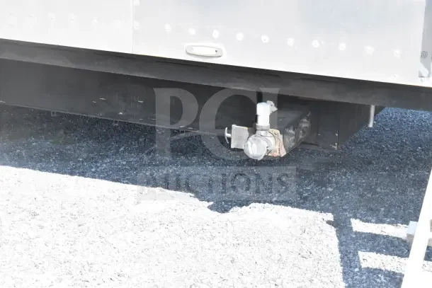 2021 Texino 8.5'x28' food trailer underside, showcasing trailer hitch connector and metal framework.