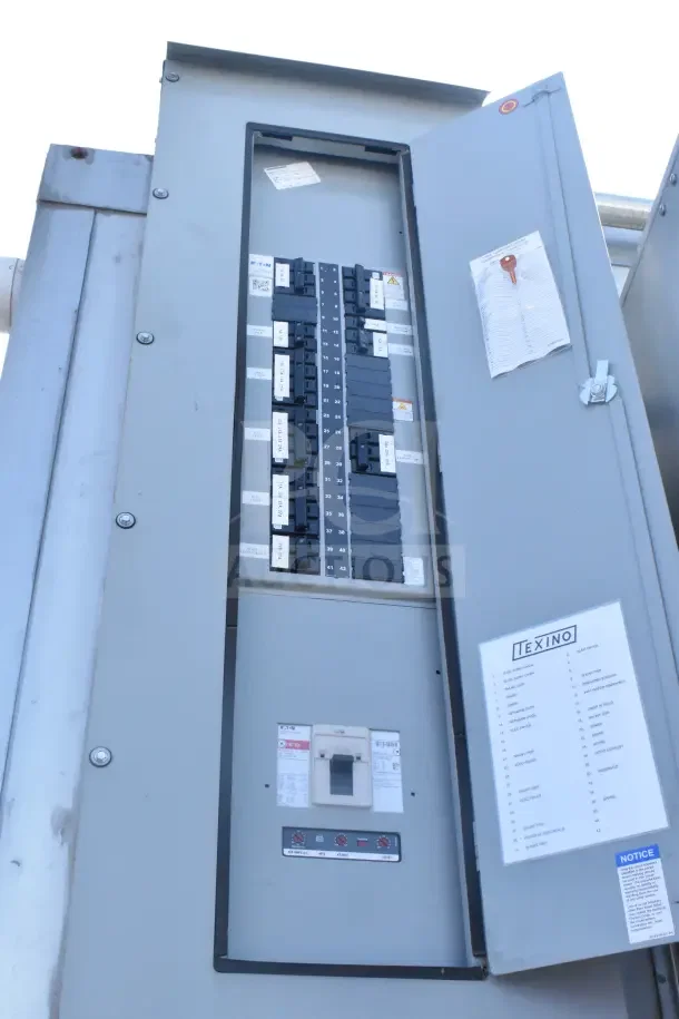Electrical panel of 2021 Texino food trailer with Texino label and breaker list visible. Door open showing circuit breakers.