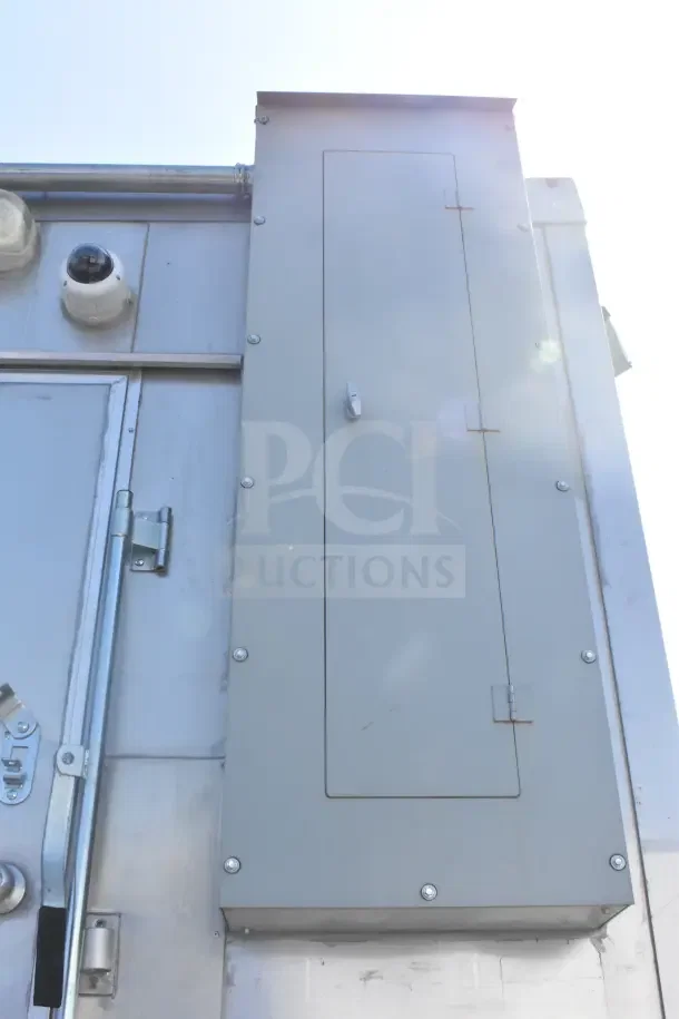 2021 Texino 8.5'x28' food trailer exterior, featuring a panel and security camera. Model includes CaptiveAire system.