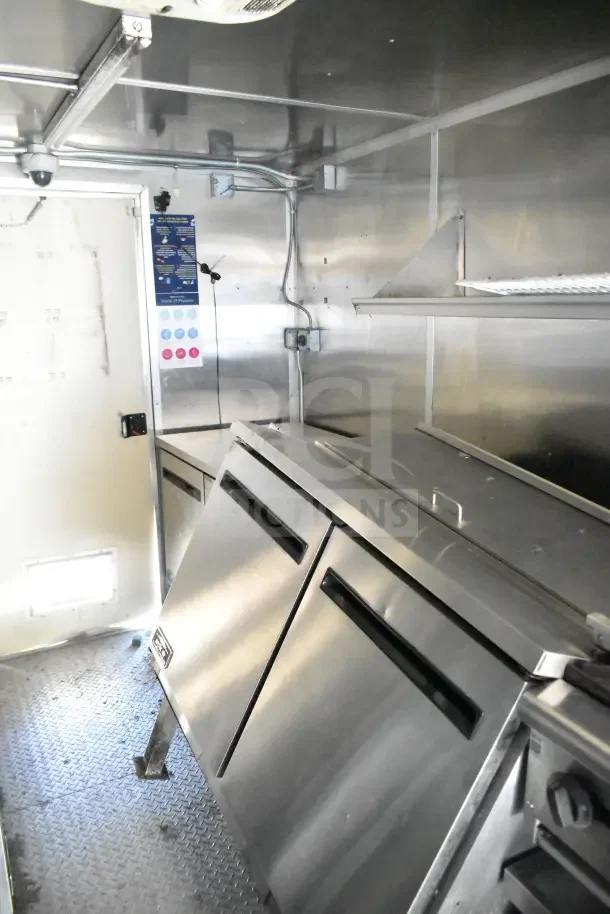 2020 Diamond Cargo 24' kitchen trailer interior, showcasing Arctic Air refrigeration units and stainless steel equipment.