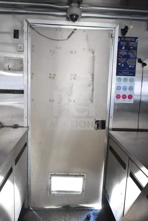 2020 Diamond Cargo 24' commercial kitchen trailer; interior view showing stainless steel counters and door.