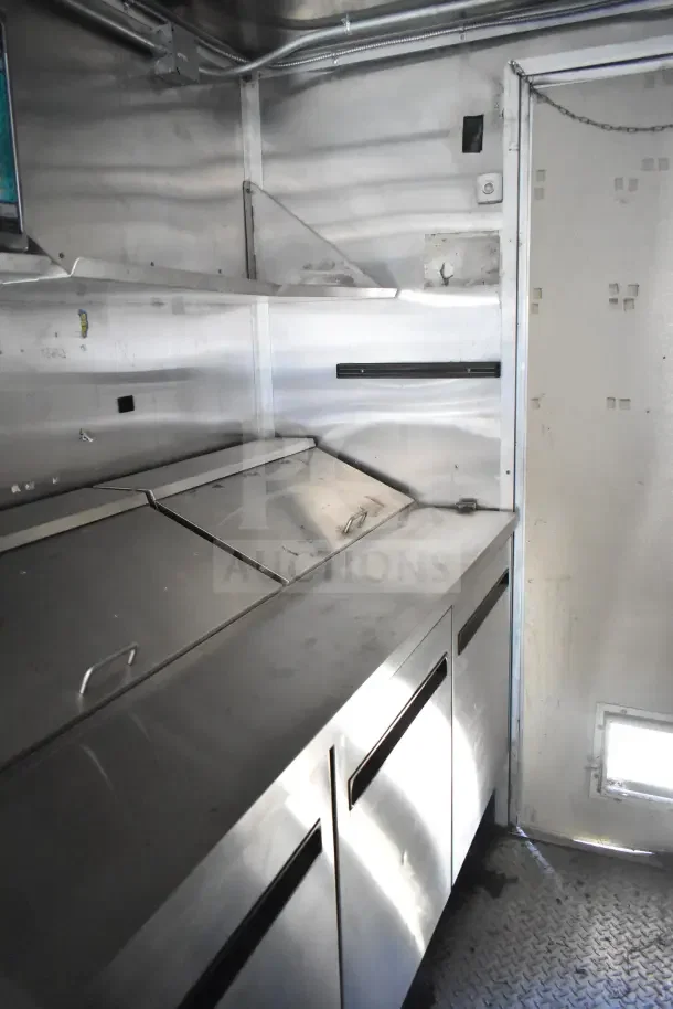 2020 Diamond Cargo 24' kitchen trailer interior, stainless surfaces, refrigeration, grease hood, used condition.