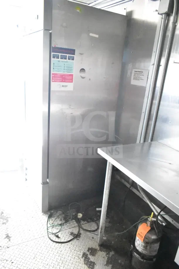 2020 Diamond Cargo 24' kitchen trailer interior, featuring stainless steel surfaces and safety signage. Operational condition.