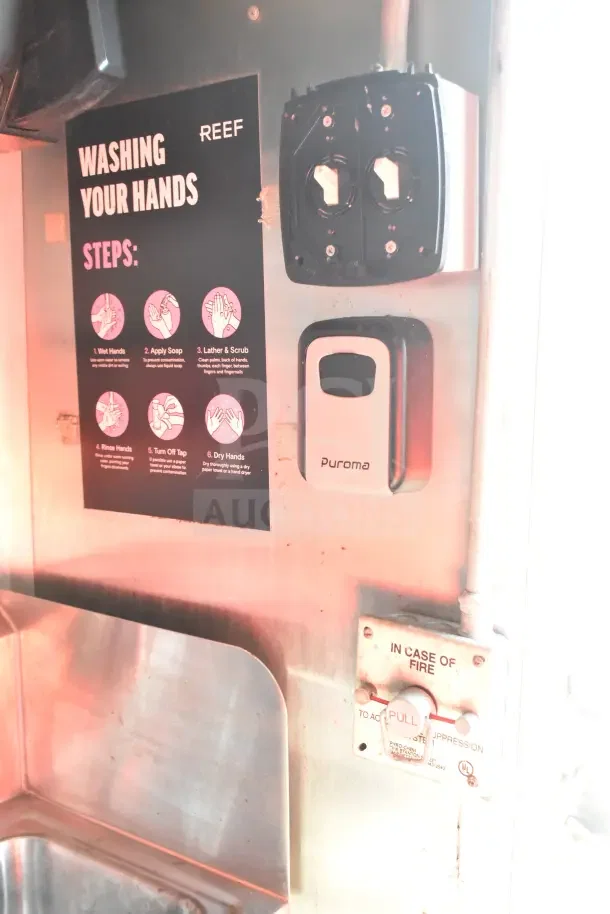 Control panel in 2020 Diamond Cargo 24' commercial kitchen trailer. Features labeled fire suppression system and handwashing guide.