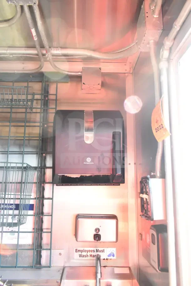 2020 Diamond Cargo kitchen trailer interior showing Georgia-Pacific paper towel dispenser, handwash sign, and electrical wiring.