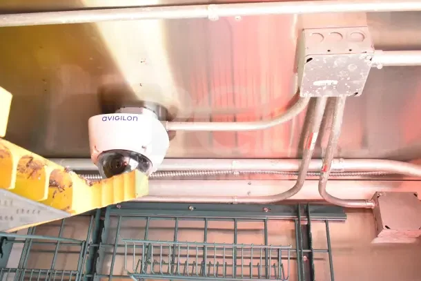 Avigilon security camera inside a 2020 Diamond Cargo 24' Commercial Kitchen Trailer. Visible wiring and metal shelving.