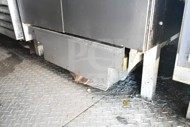 Diamond Cargo commercial kitchen trailer interior, showing flooring and lower metal fixtures. Test equipment and setup.