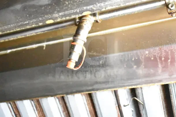 2020 Diamond Cargo kitchen trailer exhaust detail, featuring a metal pipe fitting with an orange cap.