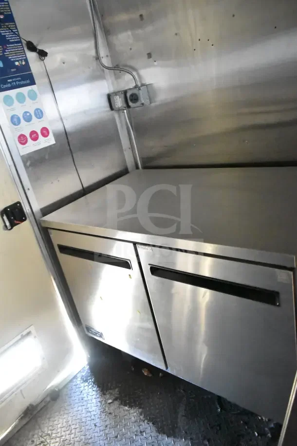 2020 Diamond Cargo commercial kitchen trailer interior showing Arctic Air refrigeration unit with stainless steel finish.