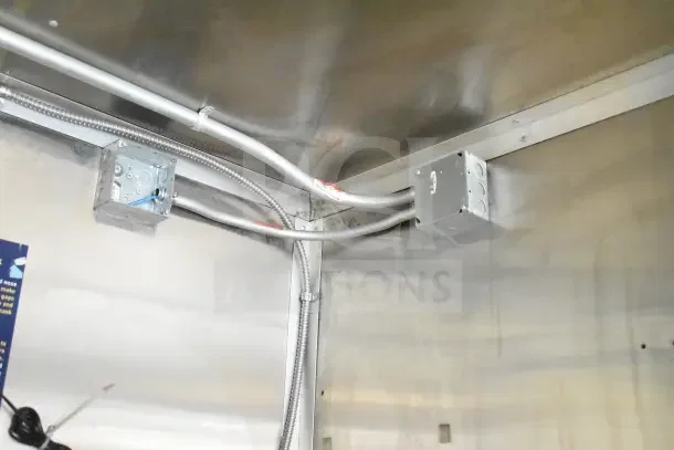 Electrical wiring and metal junction boxes inside a Diamond Cargo 24' commercial kitchen trailer, 2020 model.