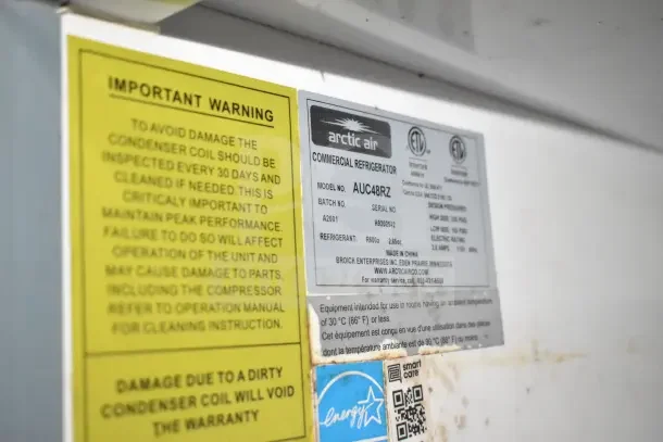 Arctic Air commercial refrigerator label, model AUC48RZ, serial H9202542, includes warning for condenser coil maintenance.
