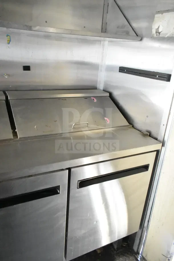 2020 Diamond Cargo 24' kitchen trailer interior showing stainless steel refrigeration unit with metal handles.