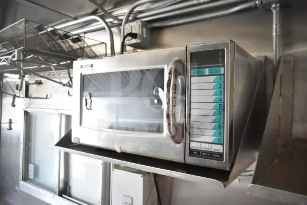 Sharp commercial microwave oven in 2020 Diamond Cargo kitchen trailer, featuring numeric control panel, stainless steel finish.