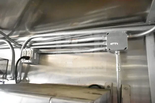 Interior view of 2020 Diamond Cargo 24' commercial kitchen trailer ceiling, showing electrical conduit and junction box wiring.