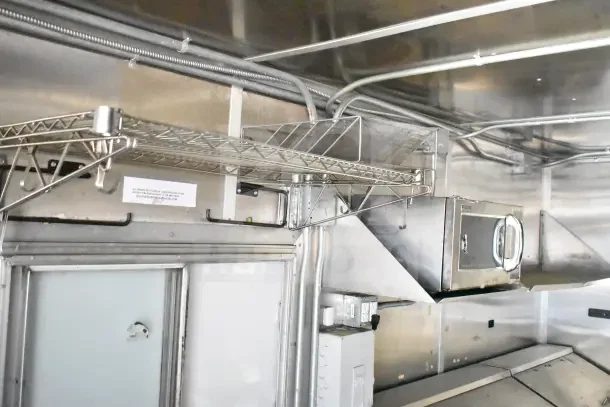 2020 Diamond Cargo 24' kitchen trailer interior with wiring, metal shelving, and stainless steel surfaces.