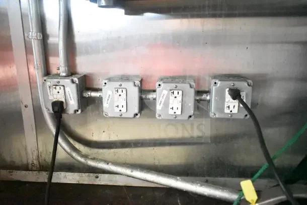 Electrical outlets in Diamond Cargo kitchen trailer, labeled for specific equipment connections, showing secure wiring.