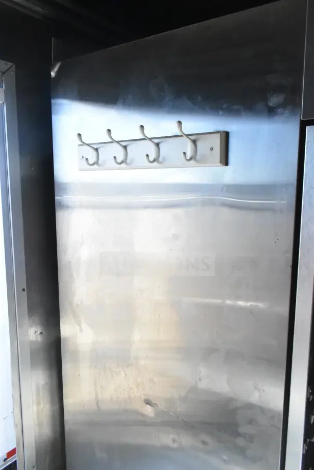 Interior view of a 2020 Diamond Cargo commercial kitchen trailer, showing stainless steel walls with mounted hooks.