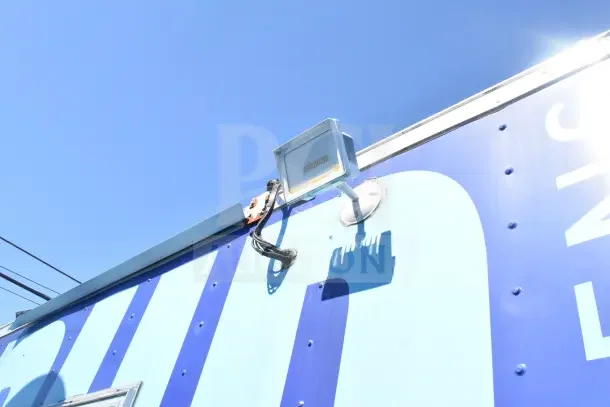 Exterior detail of a 2020 Diamond Cargo 24' kitchen trailer showing mounted light fixture against blue sky.