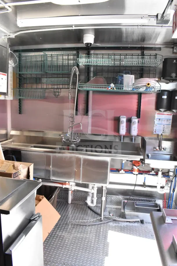 2022 Rock Solid Cargo 8.5x28 Ghost Kitchen Trailer interior with stainless steel sink and shelves.