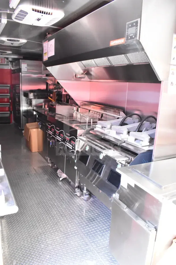 2022 Rock Solid Cargo 8.5x28 trailer kitchen, features SaniServ shake machine, Henny Penny fryer, Garland griddle, CaptiveAire hood.