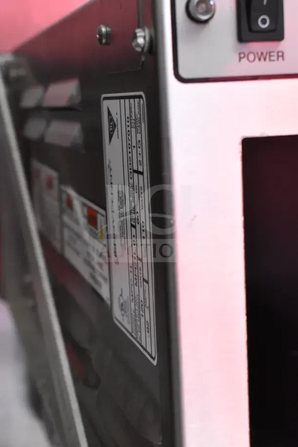 Close-up of the Henny Penny EEG-253 fryer control panel in the Rock Solid Cargo ghost kitchen trailer, showing power switch and serial label.