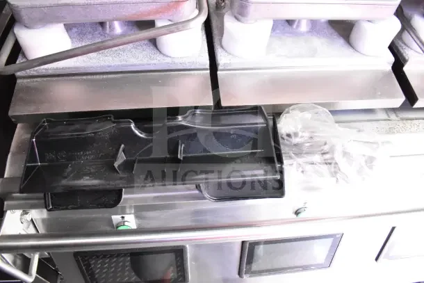 2022 Rock Solid Cargo ghost kitchen trailer interior, featuring sleek metal surfaces and professional kitchen equipment controls.